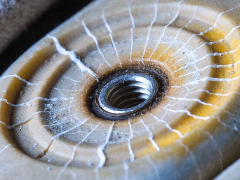 Thread channel inspection showing chemical degradation patterns Macro photography showing thread degradation in spike attachment point